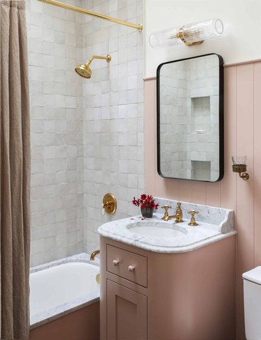Pink bathroom backsplash with pink cabinetry