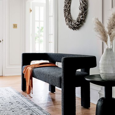 neutral entryway with black boucle bench