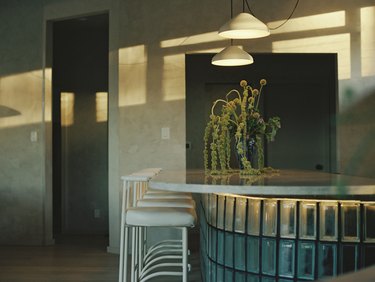 The base of the kitchen's bar is made of glass blocks.