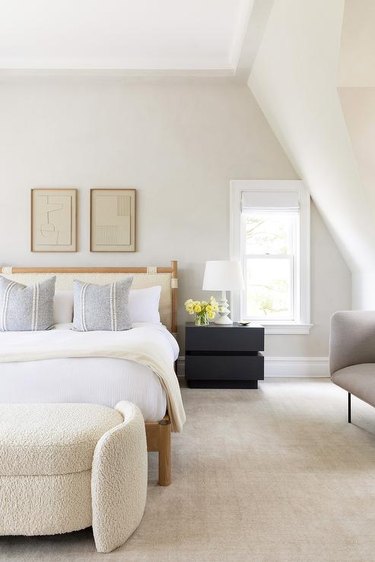 neutral bedroom with boucle headboard and bench