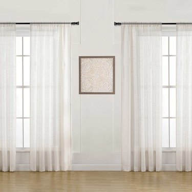 Sheer white linen curtains.