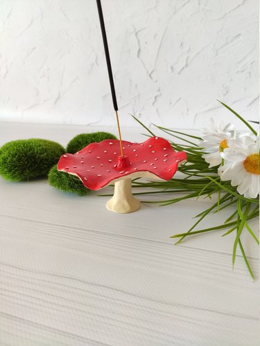 red incense holder in the shape of a mushroom