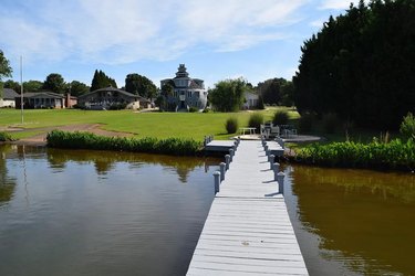A dock leading up to a grassy front yard