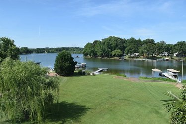 Arial view of a grass front yard and a lake