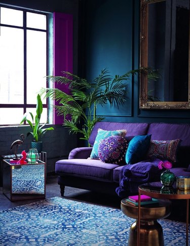 Dark jewel toned living room with blues, purple, and green.