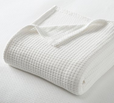 A folded white blanket