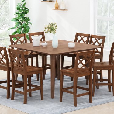 wooden counter-height table with chairs
