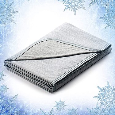 A grey blanket with snowflakes in the background
