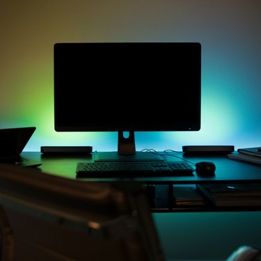 Blue and green ambient lighting behind monitor