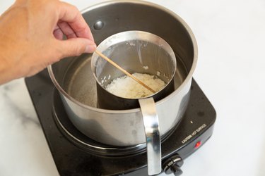 Melting wax in candle making saucepan