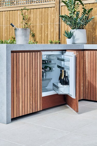 bespoke outdoor kitchen with Iroko timber and integrated fridge