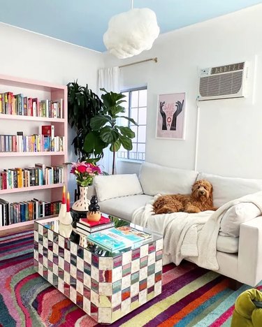 living rom with checkerboard coffee table and striped area rug