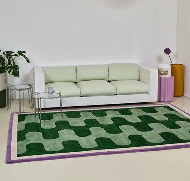 Pieces' Fortunato Rug in Verde in living room with green and white couch