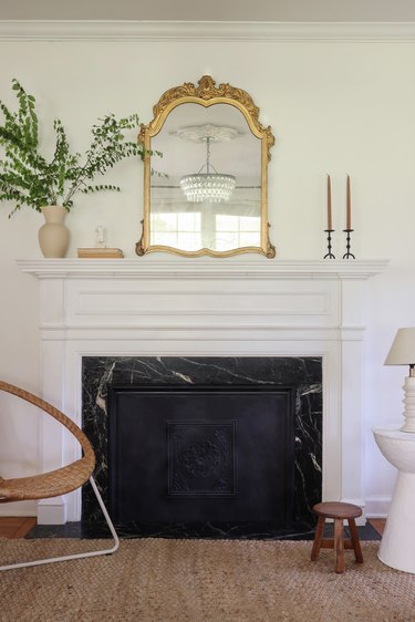 DIY summer cover inside fireplace with gold mirror above