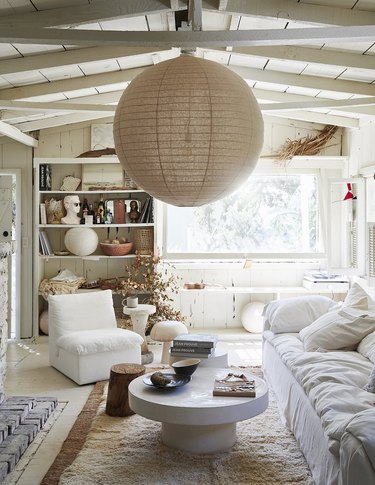 all white living room with oversize pendant