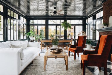 sunroom with high-gloss black paint and rust chairs