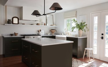Semihandmade kitchen with white walls, white counters, and brown cabinets