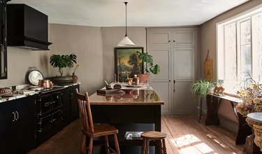 Kitchen with black cabinets and taupe walls.