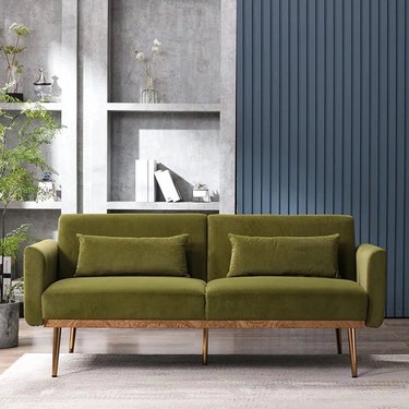 green sofa with wood base
