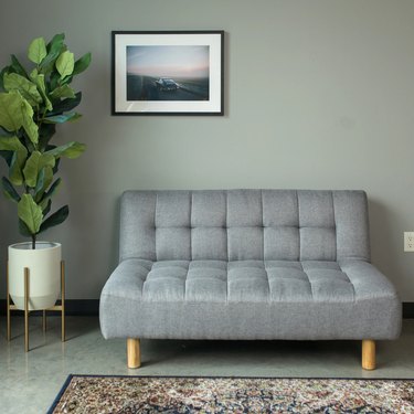 plush armless gray sleeper sofa