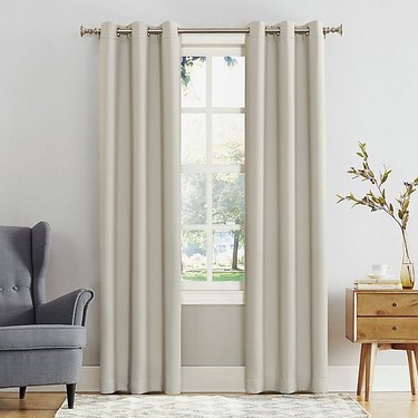 A pair of blackout curtains that block out the sun and help with sound transmission