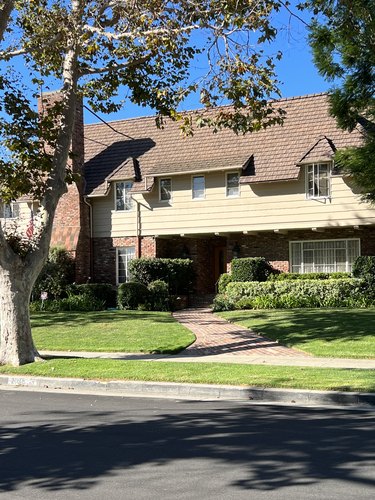 A red brick house with vanilla siding