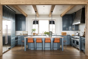 gray blue kitchen with orange accent chairs