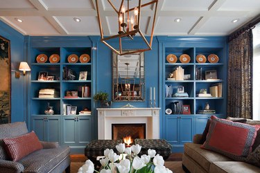 Rich blue painted room with orange and gold accents