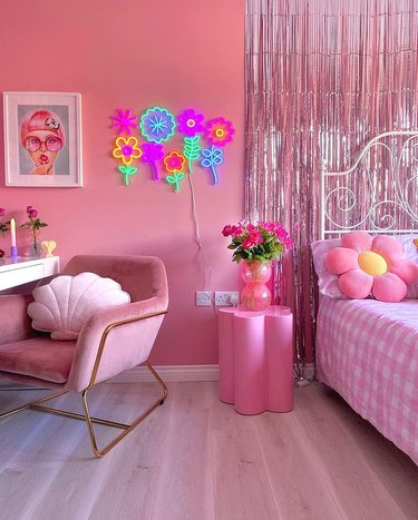 Pink bedroom with neon floral sign