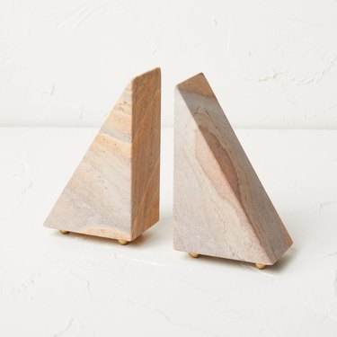 Pink and gray stone bookends that comes together to make a pyramid shape.