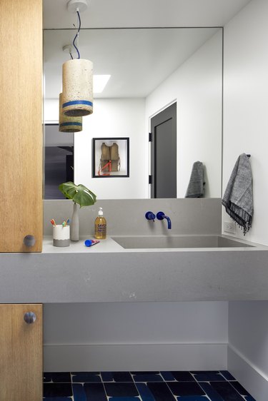 Blue and gray bathroom with pop of color