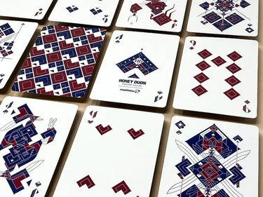 deck of playing cards in red, black, and white pattern design