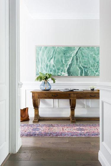 oversized photo of the ocean hanging in entryway