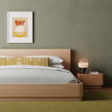 green bedroom with simple wall art