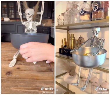On the left, small plastic skeleton with a black bowl resting on top on a wooden counter. On the right, a silver skeleton with a bowl sits on a shelf with wine bottles and other decor.