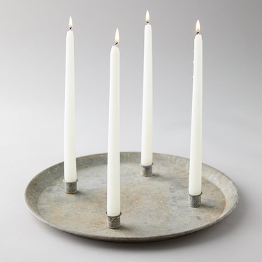 iron candle dish with four lit candlesticks