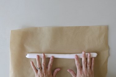 Rolling oven-bake into a log on top of parchment paper