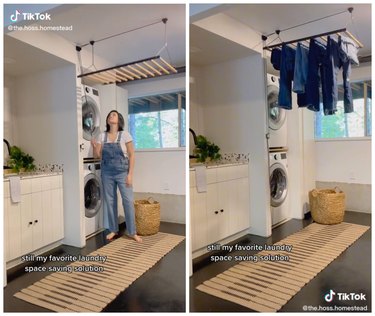 Woman pulling laundry rack down from ceiling in laundry room. Jeans hanging from drying rack hanging from the ceiling in laundry room.