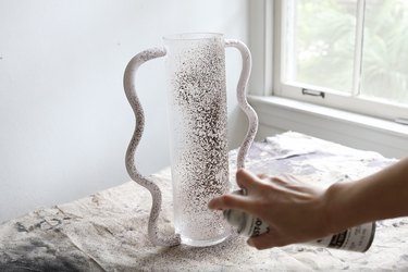 Spray painting wavy vase with brown textured stone paint