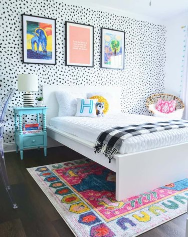 Bedroom with black and white stenciled accent wall.