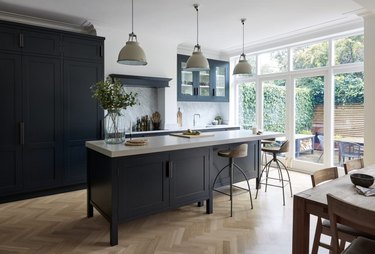 herringbone kitchen flooring with black cabinets