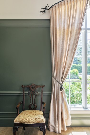 green walls and cream curtains