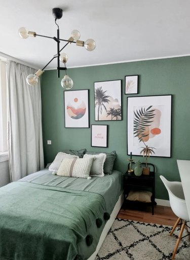 green walls and light gray curtains in bedroom