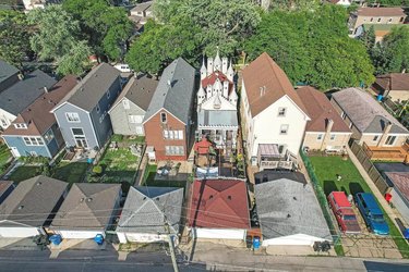 Aerial view of a castle house in a row of average houses