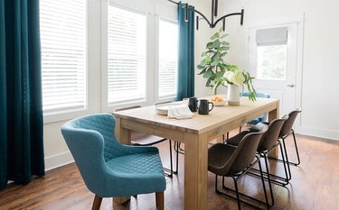 light wood dining table with chairs surrounding