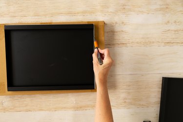 Trimming wallpaper on shelf