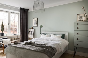 light green walls with charcoal gray curtains