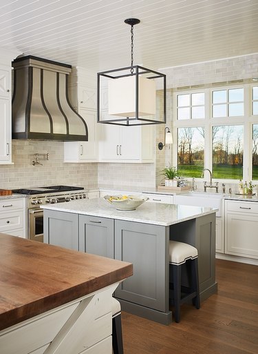 white granite countertop with gray island and modern light fixture
