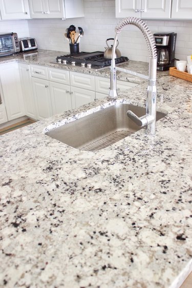 white granite countertop in kitchen with stainless steel sink