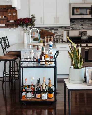 Curated bar cart in an apartment kitchen